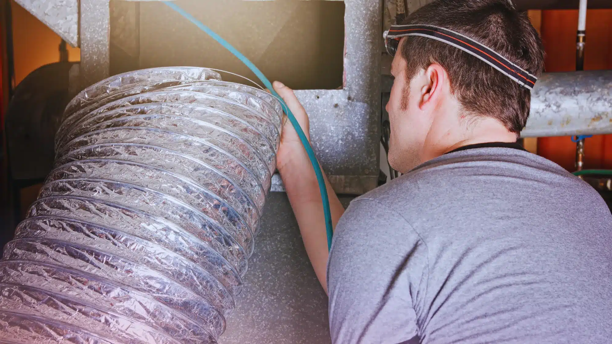 the-average-cost-of-professional-air-duct-cleaning-services-in-trumbull-connecticut HVAC technician performing professional air duct cleaning service in Trumbull Connecticut to improve indoor air quality
