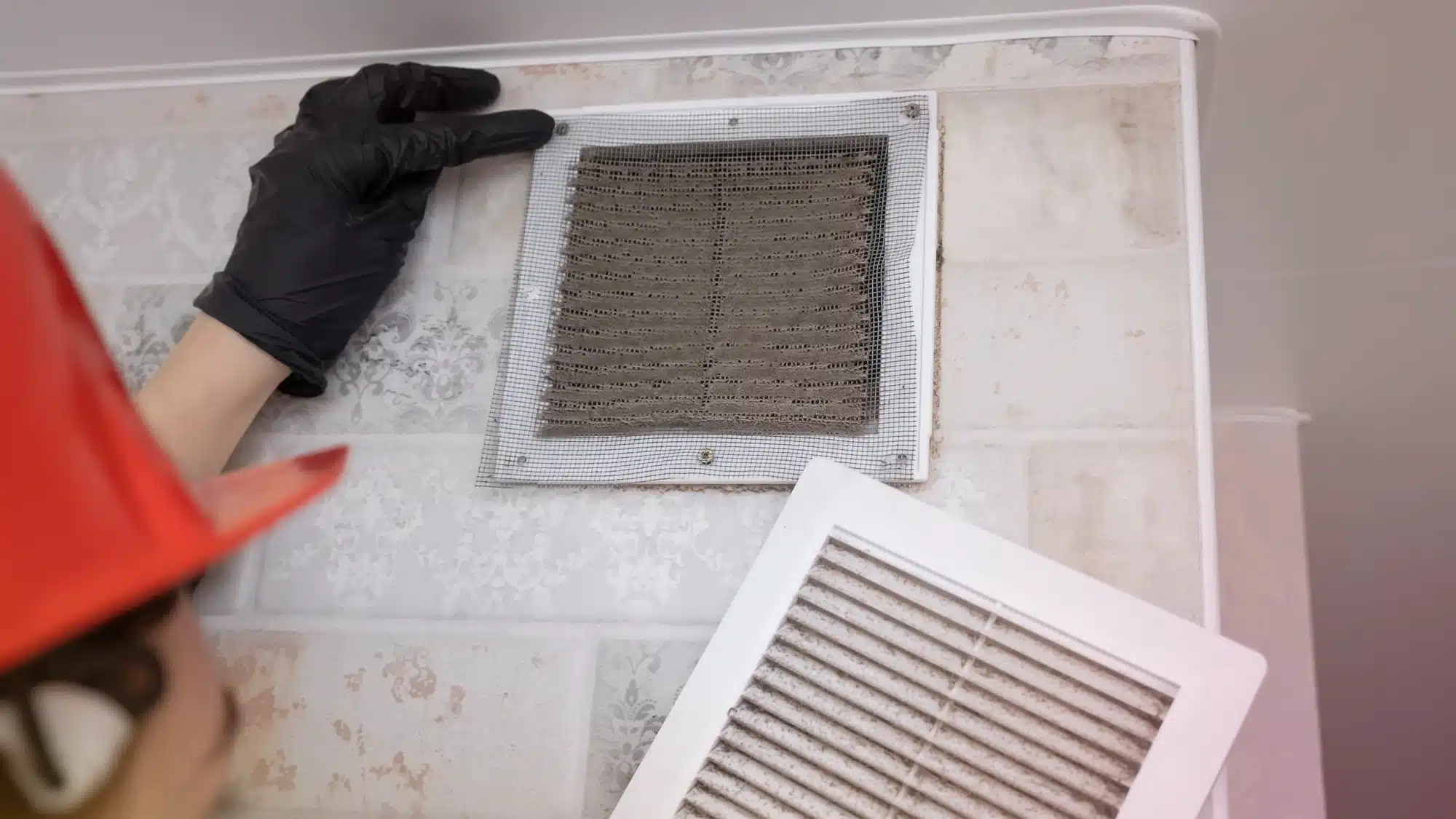 the-best-ac-duct-cleaning-companies-serving-residential-properties-in-westport-ct HVAC technician performing AC duct cleaning service in Westport Connecticut residential home using professional vacuum equipment to improve airflow and indoor air quality