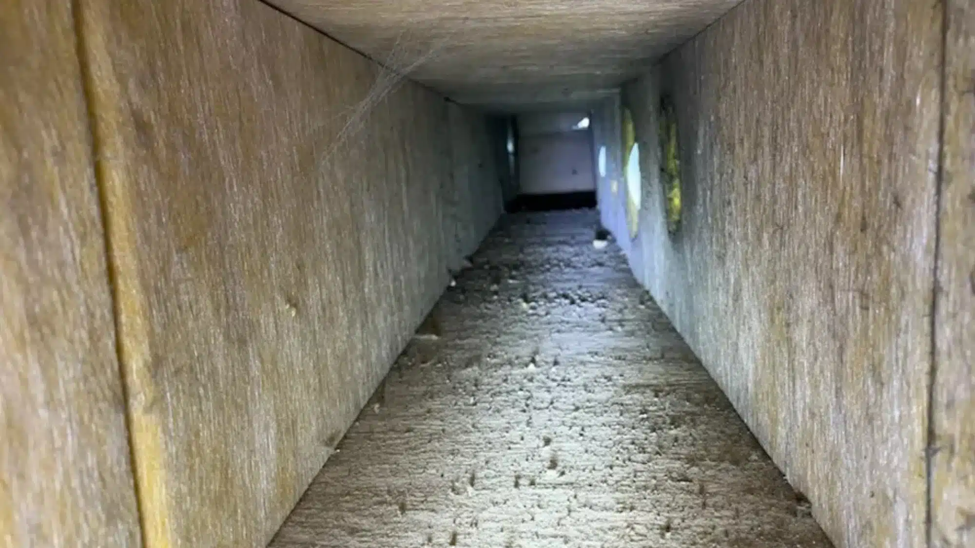 duct-board-and-lined-ductwork-understanding-mold-and-friable-material-concerns Close-up of mold growing on aged, friable material within a duct board system.